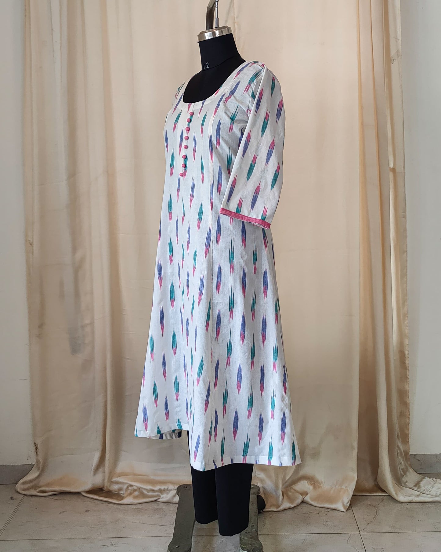 181 White ikkat fit n flare kurta with pink potlis
