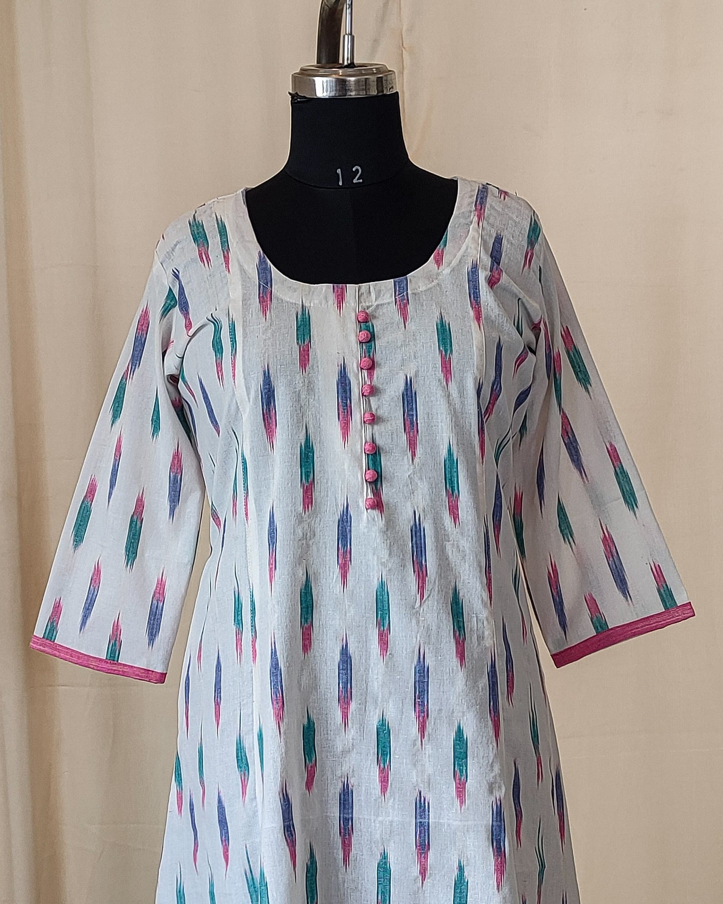 181 White ikkat fit n flare kurta with pink potlis