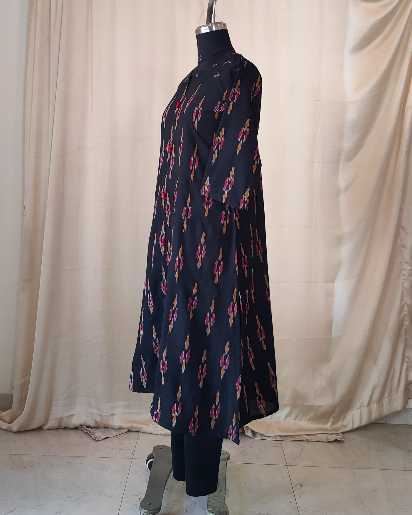 210 Black ikkat A line kurta with red potlis