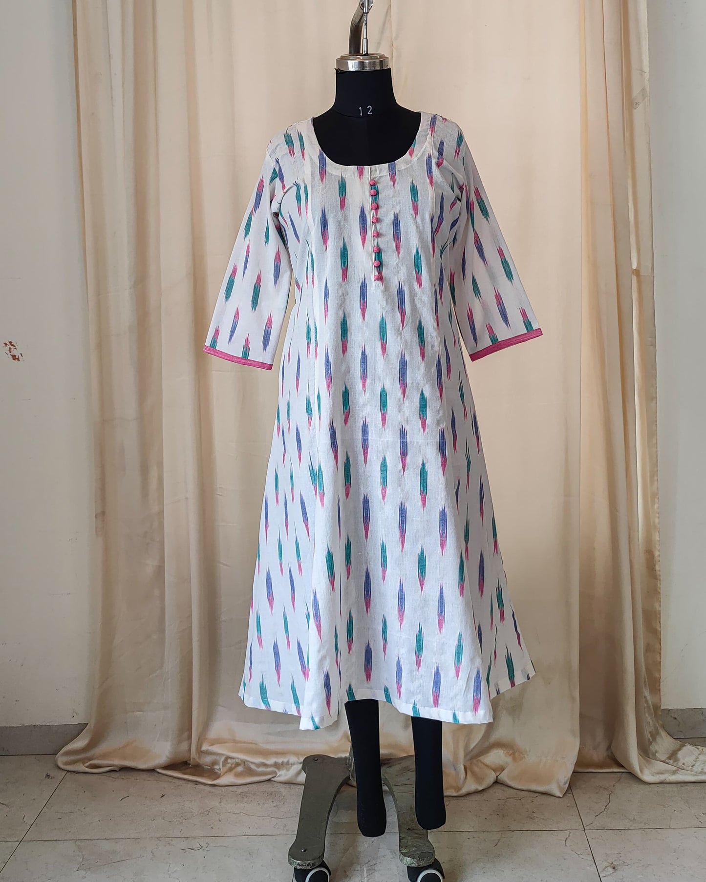 181 White ikkat fit n flare kurta with pink potlis