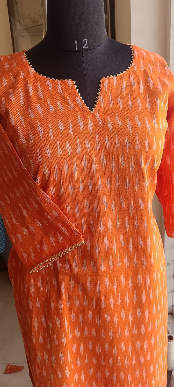 168 Orange Ikkat Cotton Kurta With Golden Lace Detailing