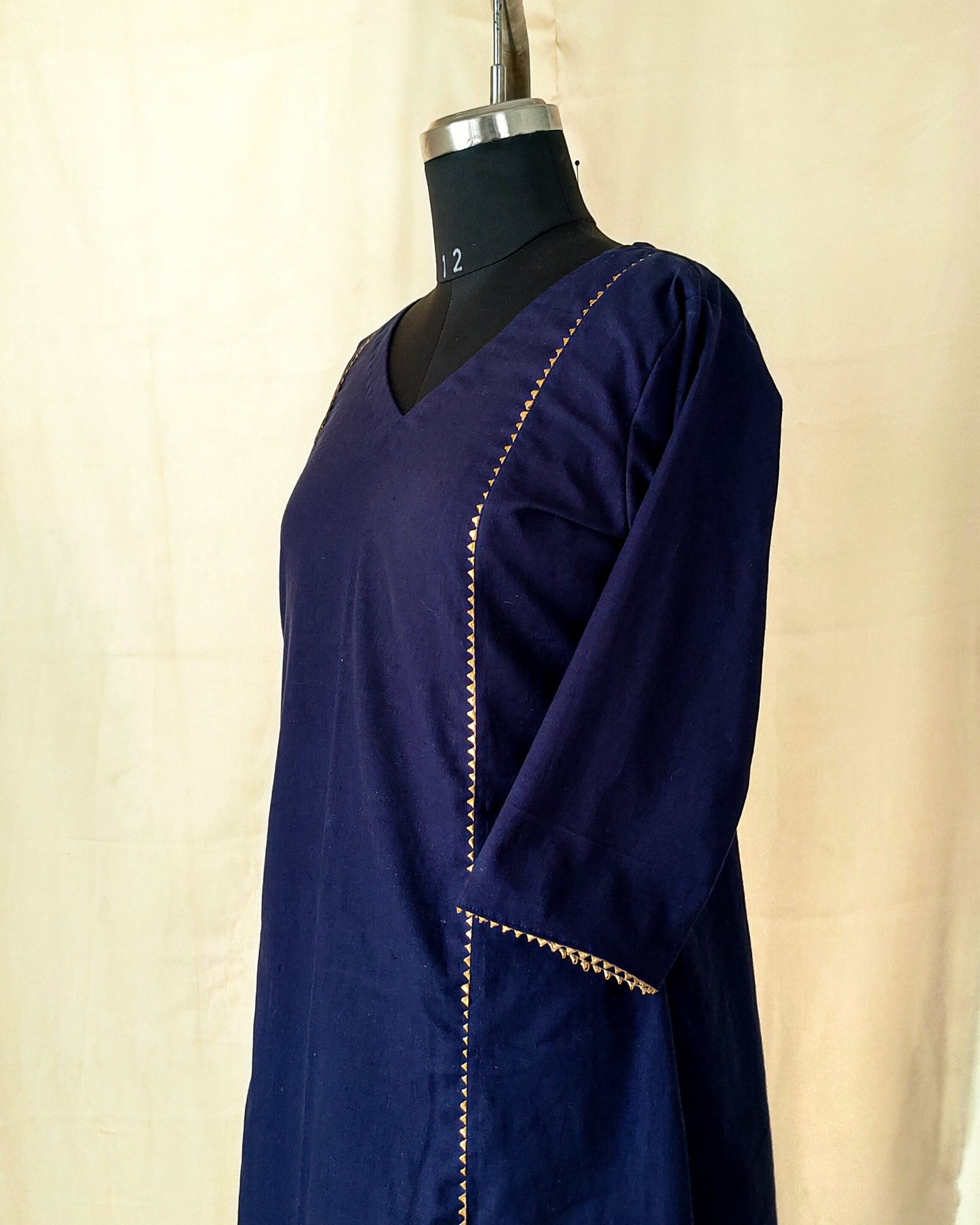 91 A Navy blue A-line kurta with golden lace