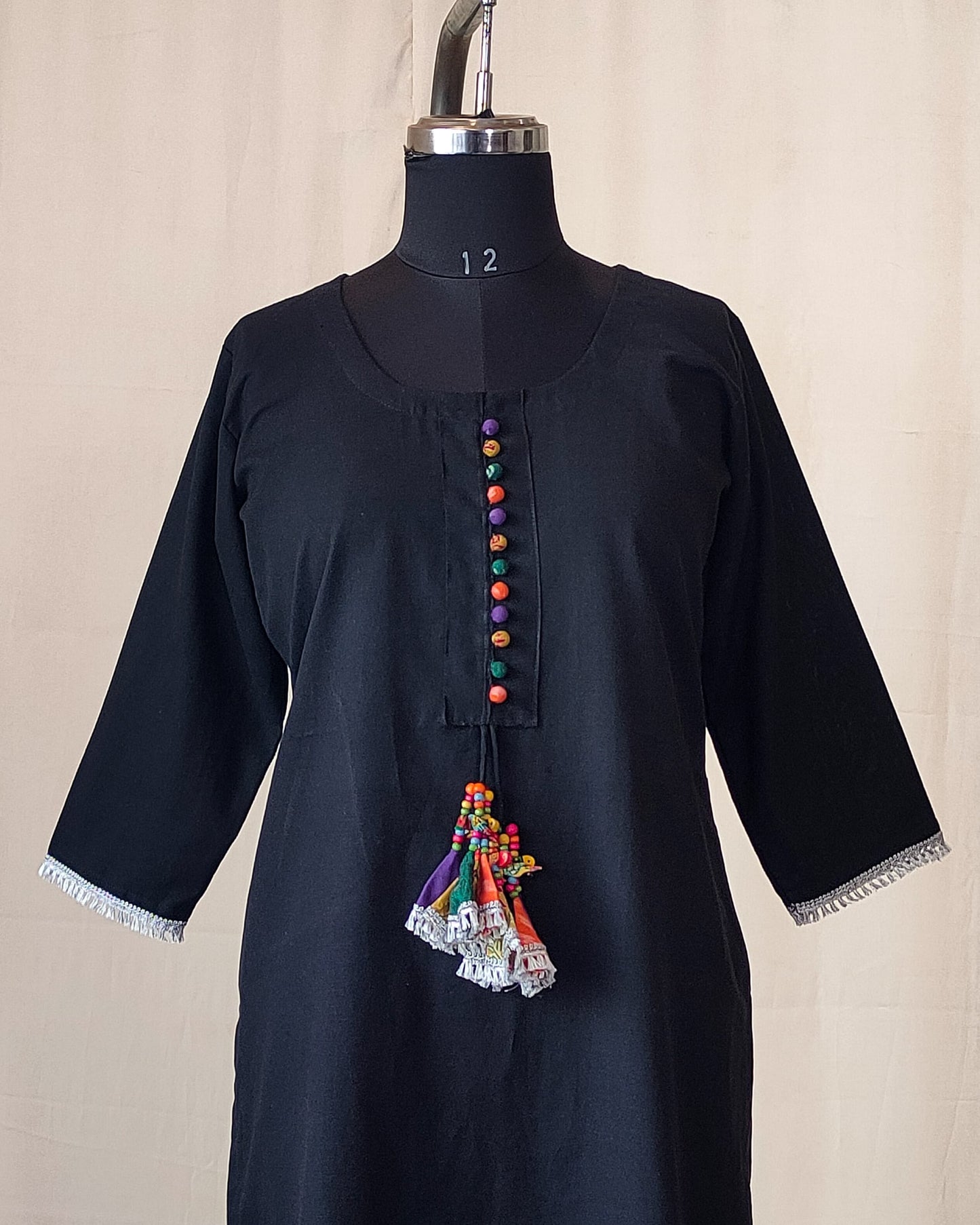 211	Black kurta with multicoloured potlis and tassels