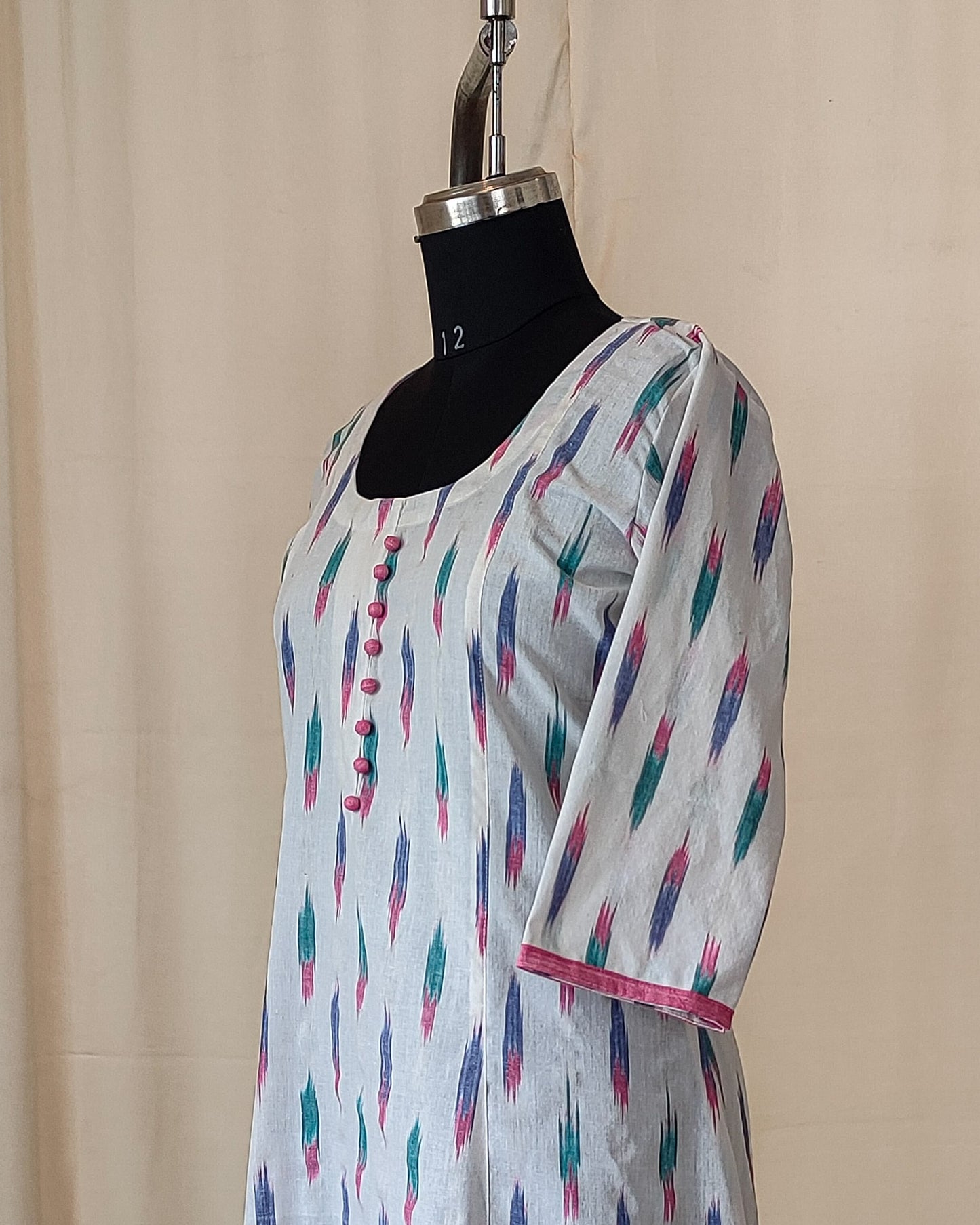 181 White ikkat fit n flare kurta with pink potlis