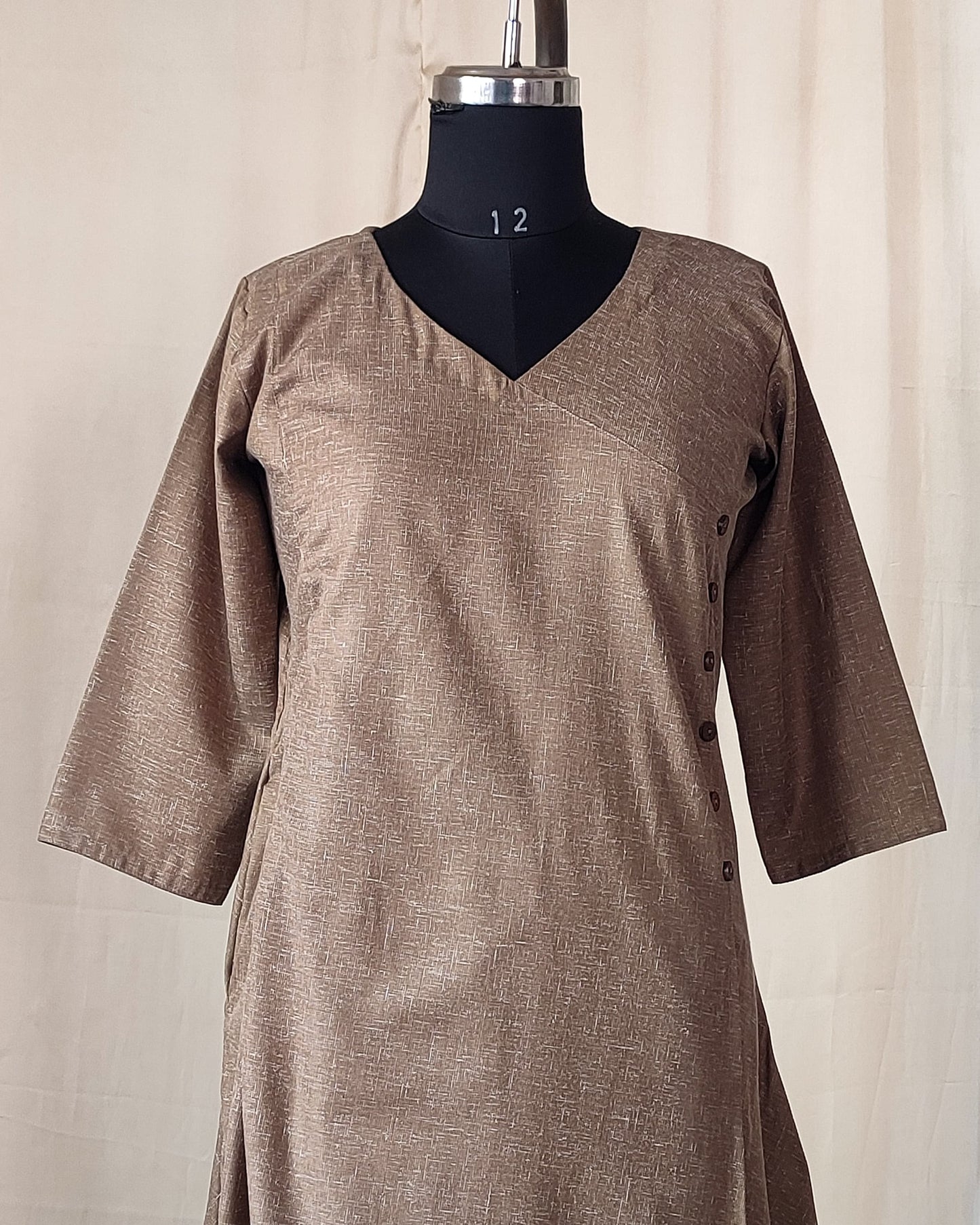 202	Beige co-ord set with overlap pattern and buttons