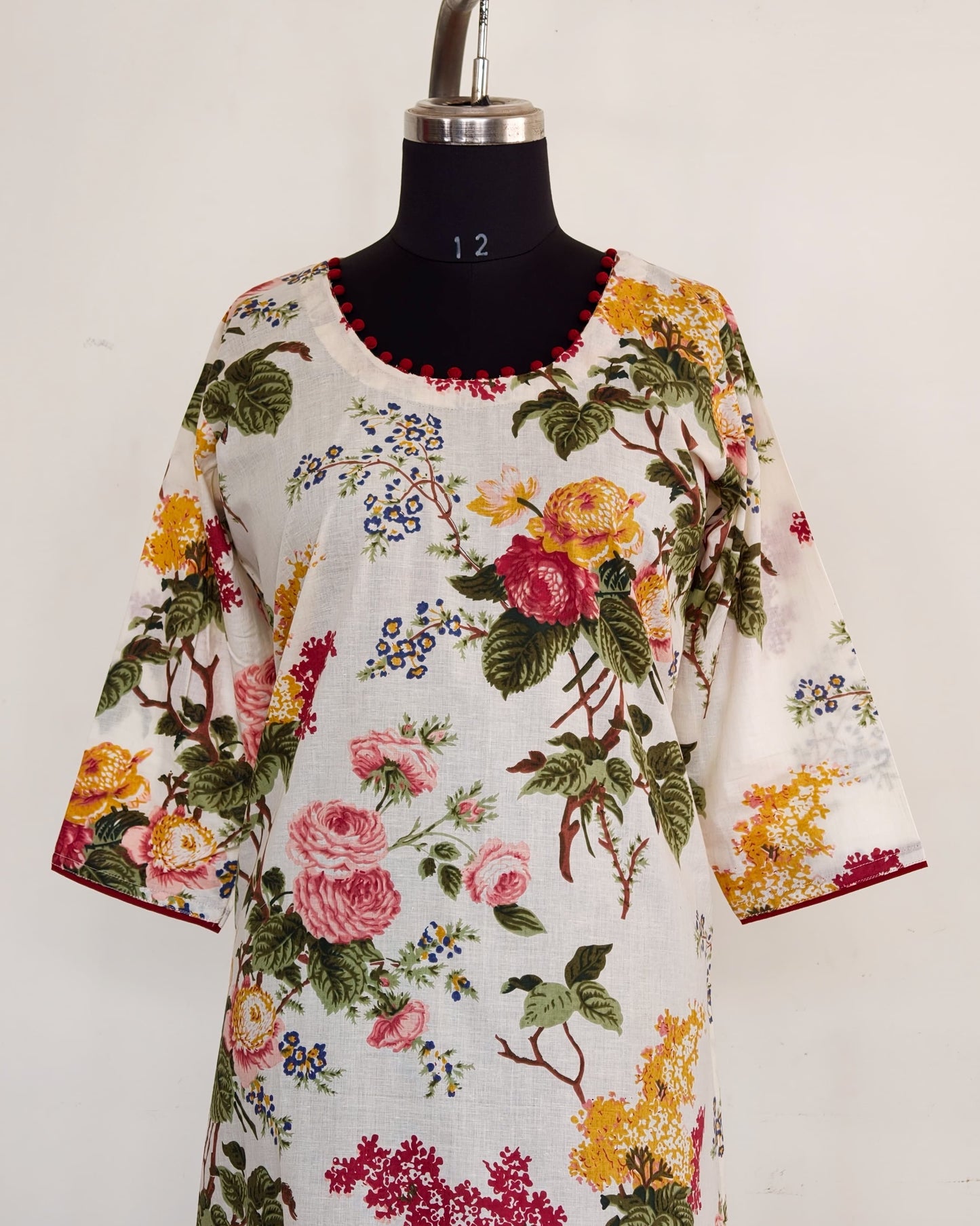 268 White floral kurta with potlis