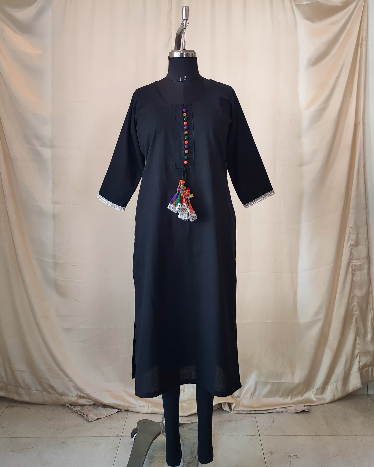 211	Black kurta with multicoloured potlis and tassels