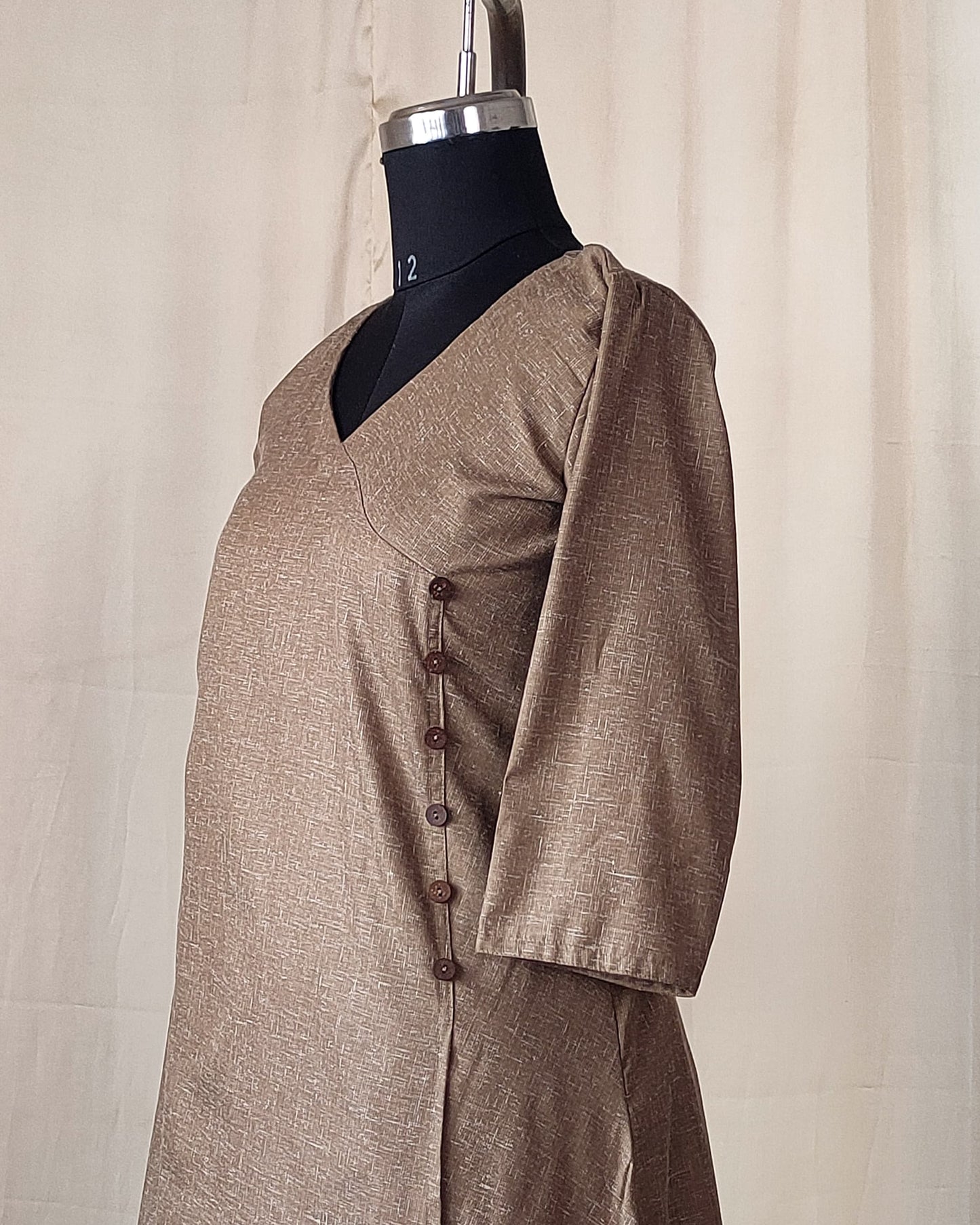 202	Beige co-ord set with overlap pattern and buttons