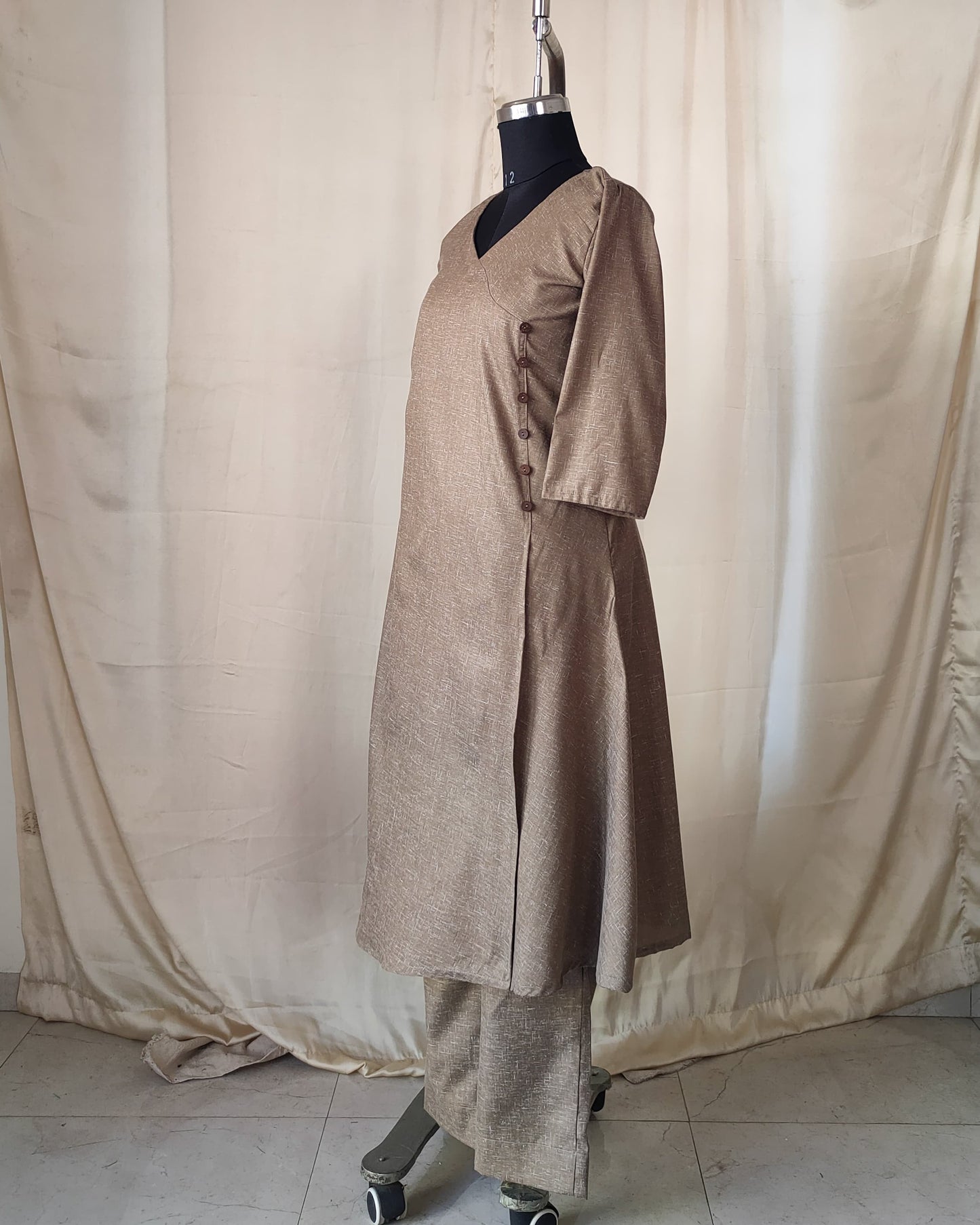 202	Beige co-ord set with overlap pattern and buttons