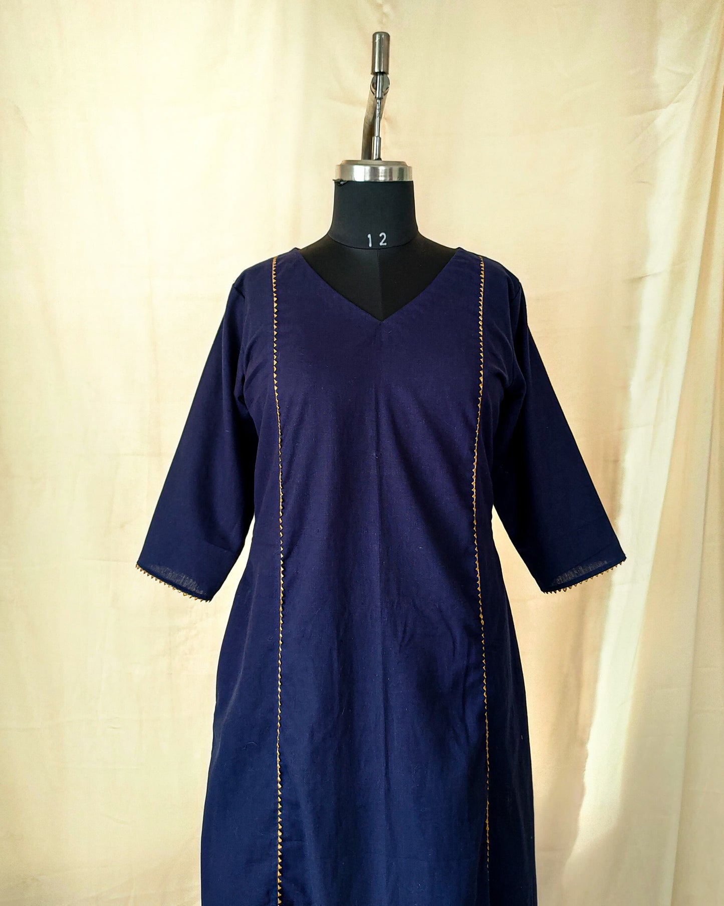 91 A Navy blue A-line kurta with golden lace
