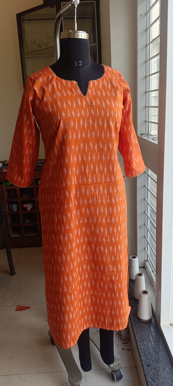 168 Orange Ikkat Cotton Kurta With Golden Lace Detailing