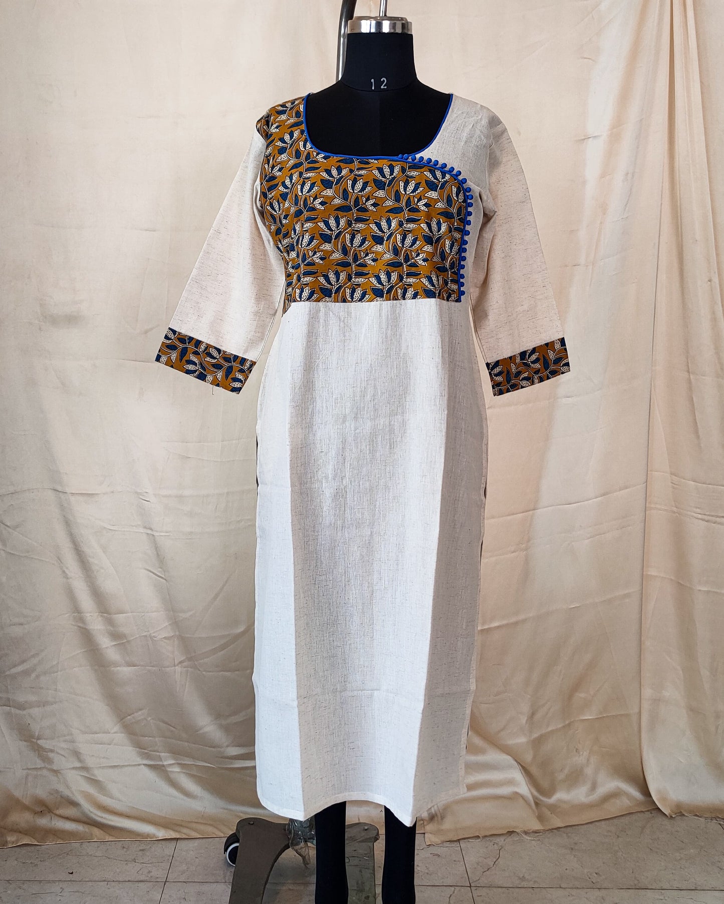 20 Cream Kurta With Blue And Mustard Yoke And Blue Potlis