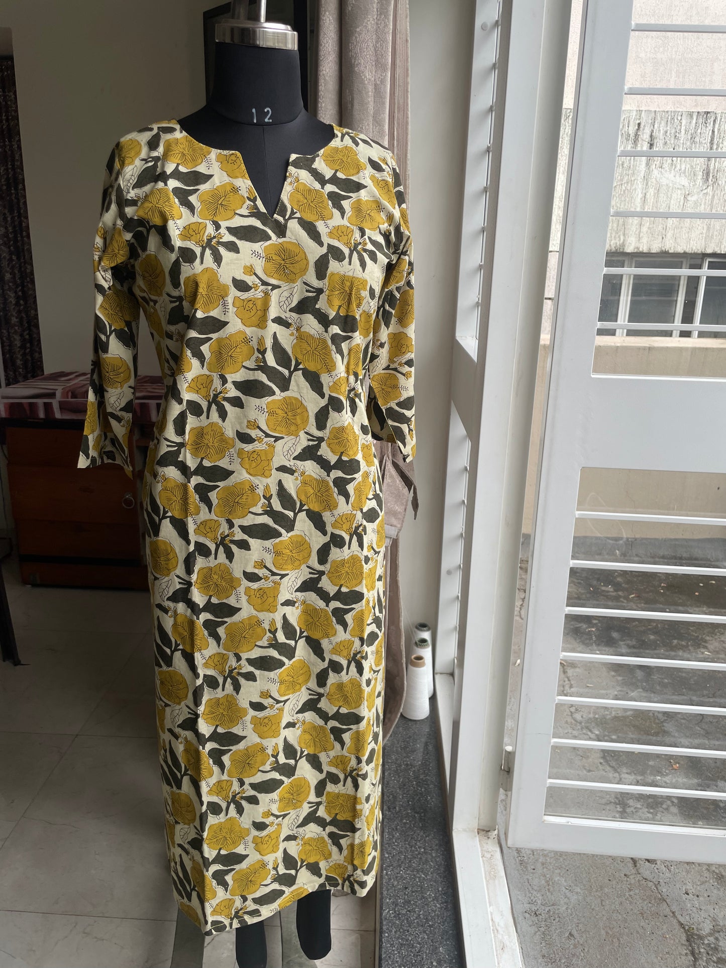 42 Cream And Mustard Printed Cotton Kurti